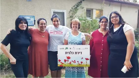  ?? (SHEKEL) ?? AT LEFT, with residents of the SHEKEL kibbutz apartment on Kibbutz Alumim.