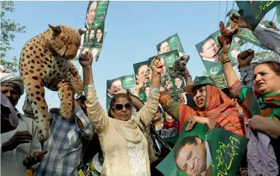  ??  ?? PML-N supporters carry posters of Prime Minister Nawaz Sharif at a rally in Lahore on Thursday. —