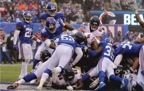  ?? SETH WENIG/AP ?? Defensive tackle Akiem Hicks (96) plunges in from the 1 during the second quarter of the Bears’ 30-27 overtime loss to the Giants on Sunday.