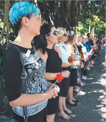  ??  ?? UNITED: The sombre Red Rose rally on the Cairns Esplanade yesterday. Picture: STEWART McLEAN