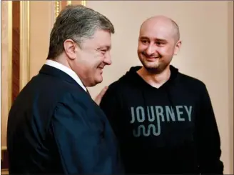  ?? The Associated Press ?? Ukrainian President Petro Poroshenko, left, and Russian journalist Arkady Babchenko meet Wednesday in Kiev, Ukraine. Babchenko, who was reported shot dead in the Ukrainian capital on Tuesday, showed up at a news conference on Wednesday, saying the...