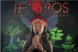  ?? Amazonas. Photograph: Andre Coelho/EPA ?? Vanda Ortega Witoto speaks in Rio de Janeiro, Brazil, in December 2021. If she is successful, she will be the first Indigenous Brazilian to win office in a general election in