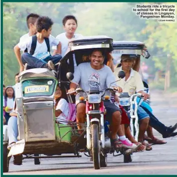  ?? CESAR RAMIREZ ?? Students ride a tricycle         
 "                   of classes in Lingayen,
Pangasinan Monday.