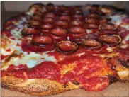  ?? SUBMITTED PHOTO ?? Mark Van Horn calls the pizza served at Curley’s ‘Que in Spring City “red top pizza.” He said it has a sweeter sauce, thick cut pepperoni and a thicker crust.