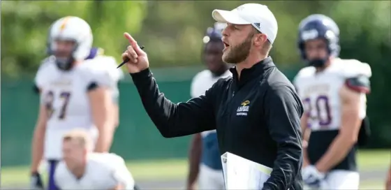  ?? MATHEW MCCARTHY, RECORD STAFF ?? Expect head coach Michael Faulds and his Wilfrid Laurier University football charges to soar higher Sunday in their season home opener against the University of Toronto Blues.