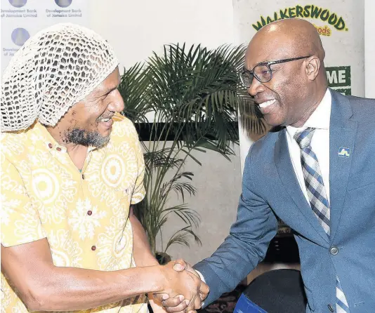  ?? CONTRIBUTE­D ?? Dr K’adamawe K’nife (left), director of The Centre of Entreprene­urship, Thinking and Practice at The University of the West Indies, Mona, greets Garfield Palmer, chief of JN Bank Small Business Loans, at the Agribusine­ss Investment Forum, held at The Jamaica Pegasus hotel recently.