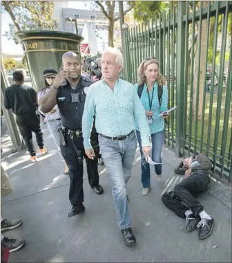  ?? Allen J. Schaben Los Angeles Times ?? JOHN COX tours the skid row area in Los Angeles. The Republican businessma­n trails Democratic Lt. Gov. Gavin Newsom by 23 percentage points in the latest USC / Times survey of likely voters.