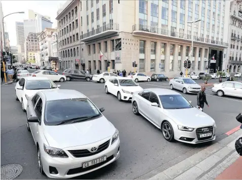  ?? Photo: Henk Kruger ?? Uber drivers in Cape Town. Uber’s disruption of the metered-taxi industry is a retelling of an old tale from before the First Industrial Revolution, says the writer.