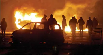  ??  ?? A history of violence: Youths set cars ablaze as they battled police in Paris in 2005