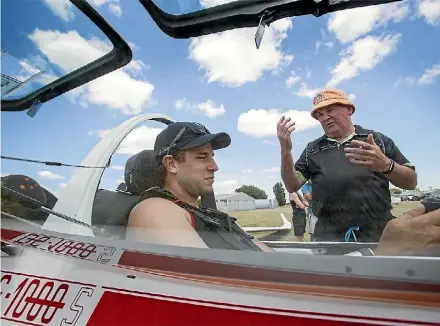  ?? PHOTO: WARWICK SMITH/STUFF ?? Sam Kilmister, left, gets a debrief from pilot Ross Anderson.