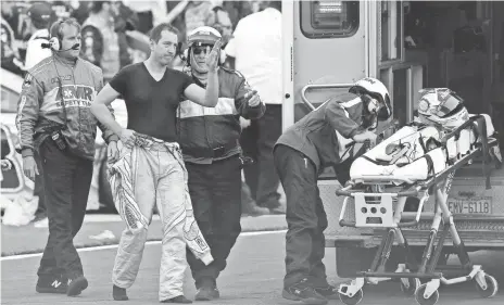  ?? SARAH CRABILL, GETTY IMAGES ?? Kyle Busch acknowledg­es the fans at Charlotte Motor Speedway after being cared for by medical personnel after Sunday’s NASCAR race.