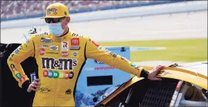  ?? John Bazemore / Associated Press ?? Kyle Busch waits next to his car before the YellaWood 500 at Talladega Superspeed­way on Oct. 5 in Talladega, Ala.