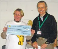  ??  ?? Julia Levick receives the cheque from Peter Davie.