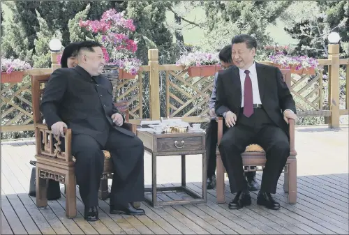  ?? PICTURES: AP PHOTO. ?? CHARM OFFENSIVE: Chinese President Xi Jinping, right, speaks to North Korean leader Kim Jong Un in Dalian in north-eastern China’s Liaoning Province.