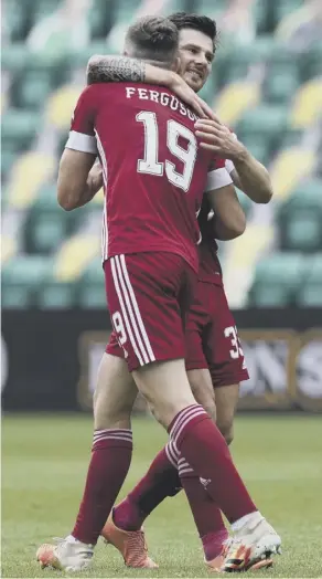  ??  ?? 0 Lewis Ferguson strokes the ball home from the penalty spot and then celebrates the goal with Aberdeen winger Matty Kennedy. Below, Hibs manager Jack Ross cuts a dejected figure on the sidelines after seeing his team slip to their first defeat of the campaign.