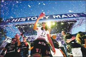 ?? STEVE MARCUS (2022) ?? Judges in the Nevada Press Foundation’s annual awards contest deemed this the Photo of the Year. The shot shows Las Vegas Aces forward A’ja Wilson celebratin­g with teammates Sept. 20, 2022, during a parade and rally for the newly crowned WNBA champions on the Strip.