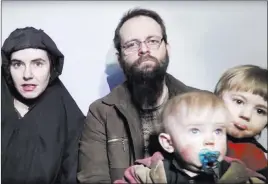  ??  ?? The Associated Press In this image from video released by the Taliban in December 2016, Caitlan Coleman of Stewartsto­wn, Pa., talks while her husband, Joshua Boyle, holds two of their children.