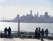  ?? ERIC RISBERG/AP ?? People look at the views of the skyline and bay from Alcatraz Island on March 15 in San Francisco.