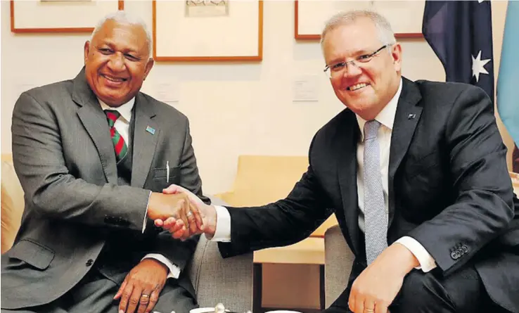  ?? Photo: PM’s Office ?? Prime Minister Voreqe Bainimaram­a and his Australian counterpar­t Scott Morrison congratula­te each other after signing the Vuvale Partnershi­p agreement in Canberra on September 16, 2019.