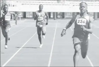  ?? ?? Ezekiel Newton powering across the line in the 200m to record his IGG double gold medal outing. (Emmerson Campbell photo)