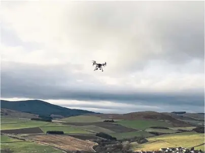  ??  ?? HIGH FLYER: A Search and Rescue Aerial Associatio­n-Scotland drone hovers above the Scottish countrysid­e
