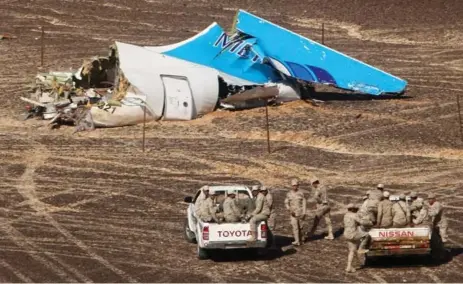  ?? MAXIM GRIGORIEV/RUSSIAN MINISTRY FOR EMERGENCY SITUATIONS VIA THE ASSOCIATED PRESS ?? Egyptian military head toward the wreckage of a passenger jet that crashed in Hassana, Egypt last weekend while en route to St. Petersburg, Russia.