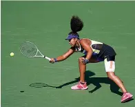  ?? AP Photo/Seth Wenig ?? ■ Naomi Osaka of Japan returns a shot to Marta Kostyuk of the Ukraine during the third round of the U.S. Open Friday in New York.