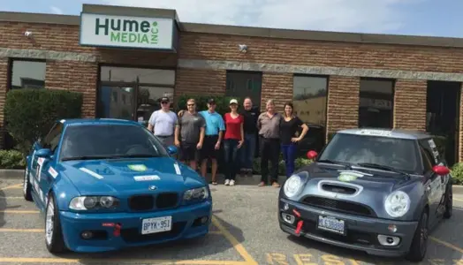  ?? COURTESY OF JOHN HUME ?? The Hume Media race team poses behind its two podium winners from last year’s Targa Newfoundla­nd race. Company owner John Hume is racing for the seventh straight year this year.