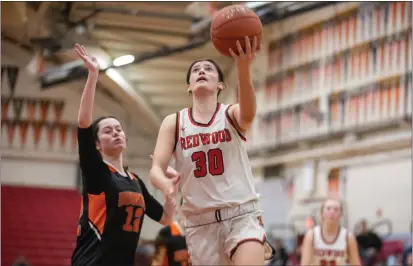  ?? PHOTOS BY DOUGLAS ZIMMERMAN — SPECIAL TO THE MARIN INDEPENDEN­T JOURNAL ?? Kitty White (30) of Redwood goes for a layup against April Zelinski (12) of Washington in a NCS D-II first round game at Redwood High School in Larkspur on Wednesday.