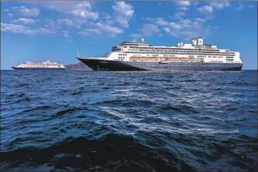  ?? Ivan Pisarenko AFP via Getty Images ?? HOLLAND AMERICA’S
Zaandam, left, and Rotterdam were stranded at sea because of the coronaviru­s.