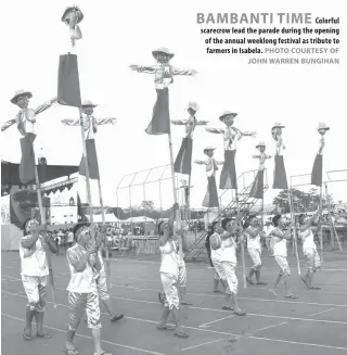  ?? PHOTO COURTESY OF JOHN WARREN BUNGIHAN ?? BAMBANTI TIME Colorful scarecrow lead the parade during the opening of the annual weeklong festival as tribute to farmers in Isabela. TARLAC: