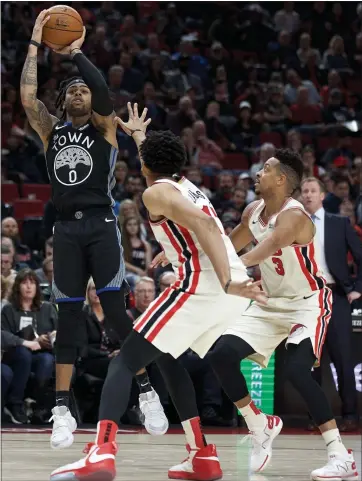  ?? CRAIG MITCHELLDY­ER — THE ASSOCIATED PRESS ?? Warriors guard D’Angelo Russell, who scored 26 points, puts up a shot against the Trail Blazers on Wednesday night.