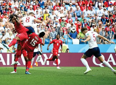  ?? GETTY IMAGES ?? . . . but England defender Stones (right) soon bursts clear of the unfair attention to make it 1-0