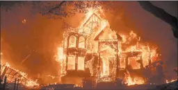  ?? NOAH BERGER/AP ?? Flames from the Glass Fire consume an inn last week in St. Helena, California. The fires of 2020 have killed 31 people and forced thousands of residents to flee across the state.