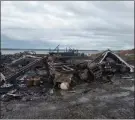  ?? The Canadian Press ?? Debris from a burnt out fish plant is scattered along the shore in Middle West Pubnico, N.S. A large fire destroyed a commercial building that was the scene of a confrontat­ion earlier in the week between Indigenous and non-Indigenous fishermen.