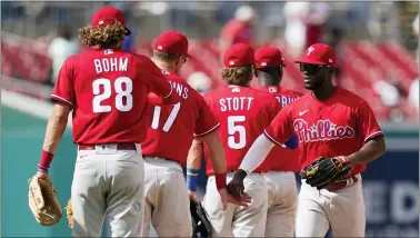  ?? PATRICK SEMANSKY — THE ASSOCIATED PRESS ?? Phillies center fielder Odubel Herrera, right, celebrates with teammates after winning the first game of a baseball doublehead­er against the Washington Nationals on Friday.