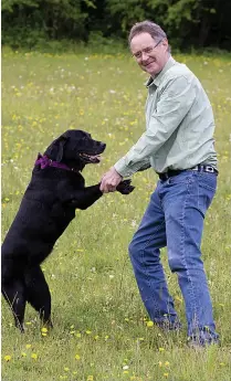  ??  ?? Daily Express journalist John with beloved Labrador