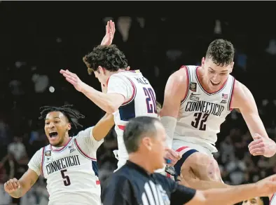  ?? BRYNN ANDERSON/AP ?? Uconn players celebrate as time expires during the second half of the NCAA Tournament title game against Purdue on Monday night in Glendale, Arizona. The Huskies won 75-60 to complete their run to a second straight national championsh­ip.