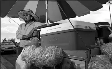  ?? STEVE MARCUS FILE (2023) ?? Street vendor Luis Sanchez works his mobile food stand in North Las Vegas in June 2023. New restrictiv­e labor laws could threaten the livelihood of many immigrant workers, half of whom work independen­tly.