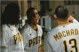  ?? ?? Juan Soto, center, jokes with Padres teammates third baseman Manny Machado, right, and first baseman Josh Bell during the fourth inning of Wednesday’s game.