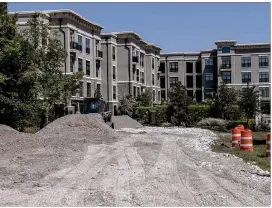  ?? GEORGE ETHEREDGE / NEW YORK TIMES ?? A temporary road leads to the Heights at Park Row apartment complex in Houston in September, after Hurricane Harvey flooded the main road to the complex. Officials say much of the $61 billion sought would combat flooding.