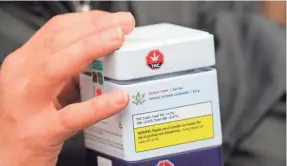  ?? TREVOR HUGHES/USA TODAY NETWORK ?? Becky Prete, 37, holds boxes of marijuana purchased at a cannabis store in British Columbia as legal sales began Wednesday.