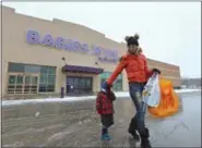  ?? CHRISTOPHE­R MILLETTE/ERIE TIMES-NEWS VIA AP ?? Jennifer Merva and her son Sebastian Merva, 4, leave Babies R Us Jan. 24 in Summit Township, Pa., after shopping for gifts for a baby shower. As part of a Chapter 11 bankruptcy reorganiza­tion, parent company Toys R Us announced on Jan. 24 that the...