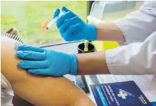  ?? DARREN STONE, TIMES COLONIST ?? Dr. Rania Gomaa injects an AstraZenec­a vaccine for Brad Styner at The Medicine Shoppe Pharmacy in Victoria.