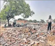  ?? HT PHOTO ?? A man stands on the rubble of demolished houses in Jewar’s Nagla Ganeshi, one of the seven villages that have been acquired for constructi­on of an internatio­nal airport.