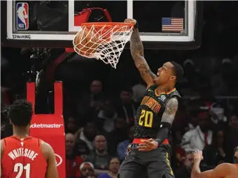  ?? AP ?? THE RIGHT STUFF: Atlanta’s John Collins dunks against Portland Saturday.