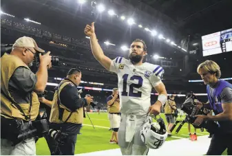  ?? Eric Christian Smith / Associated Press ?? Andrew Luck, who threw for 222 yards and two touchdowns, leaves the field after helping Indianapol­is cruise over Houston in the Colts’ first playoff game since January 2015.