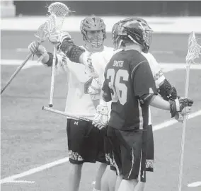  ?? KARL MERTON FERRON/BALTIMORE SUN ?? Dylan Maltz, left, was one of three Terps to finish with three goals and one assist against Eric Smith and Michigan. Maryland has outscored its past two opponents 30-15.