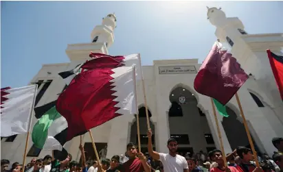  ?? (Ibraheem Abu Mustafa/Reuters) ?? PALESTINIA­NS IN the southern Gaza Strip take part in a rally on Friday in support of Qatar inside the Qatari-funded constructi­on project Hamad City.