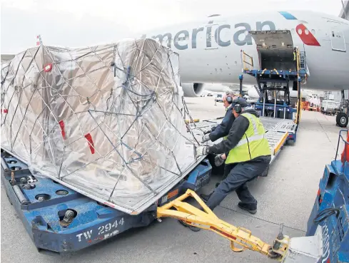  ?? AFP ?? American Airlines converts passenger planes into cargo jets to ferry supplies to Europe.